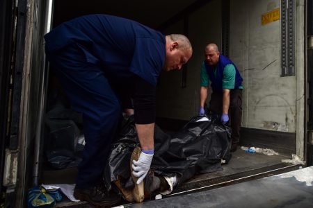 Dead bodies kept in trucks with forklift after morgues become full in Bucha