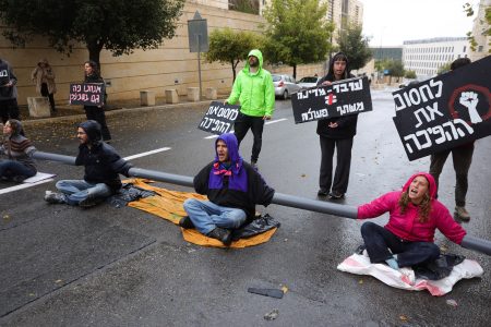 anti-government protestors chains themselves with plastic pipes in israel