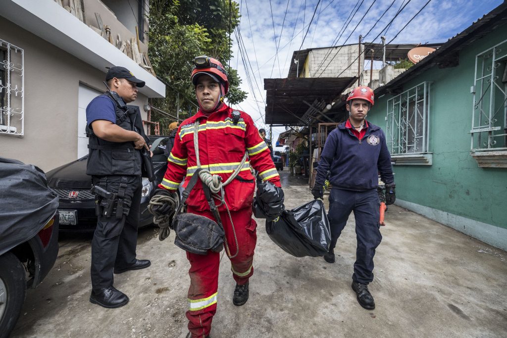 Rescuers search for people missing after a river overflowed in Guatemala City