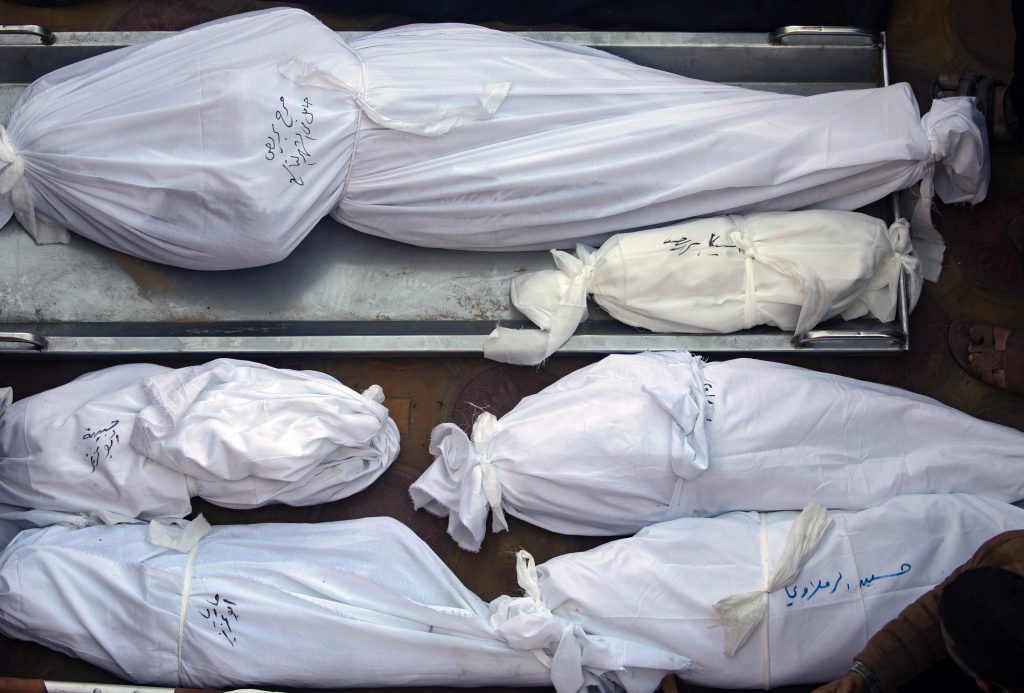 Relatives mourn over the remains of family members killed in Israeli air strike