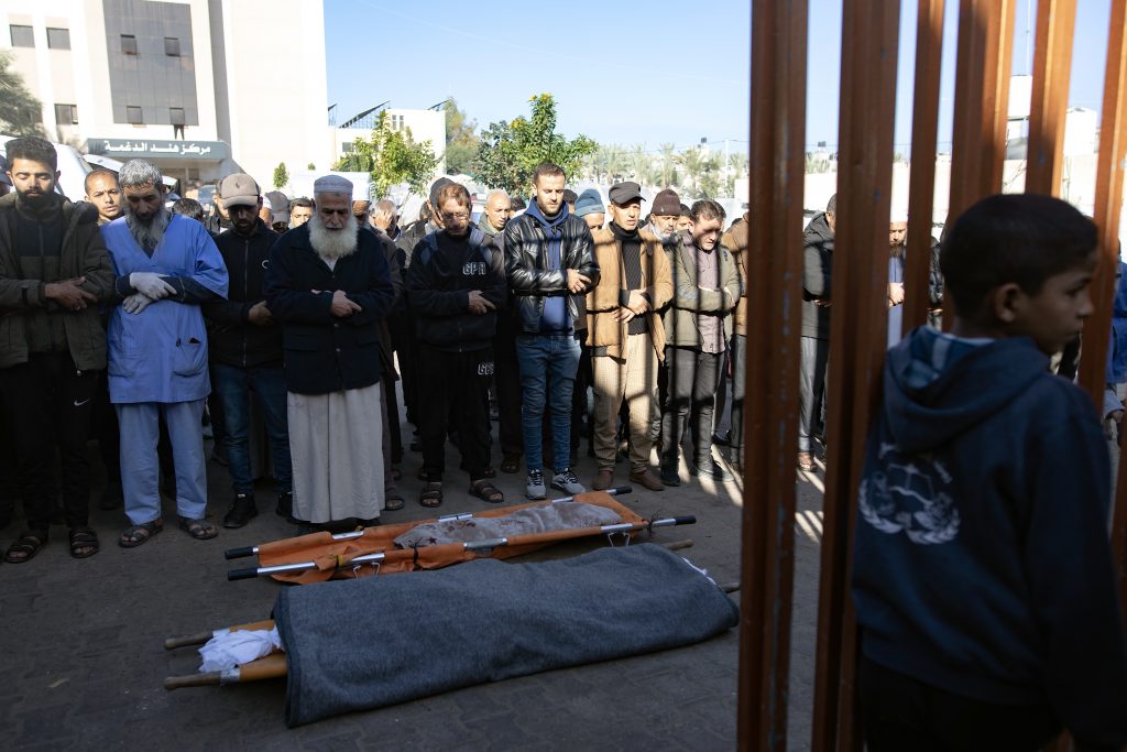 Relatives mourn over the remains of family members killed in Israeli air strike
