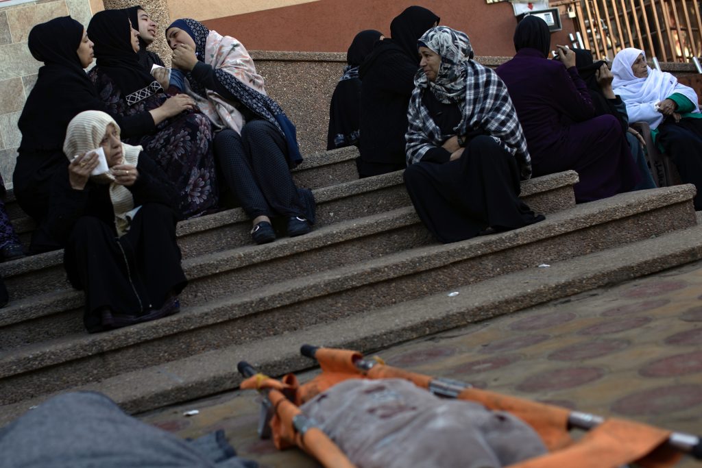 Relatives mourn over the remains of family members killed in Israeli air strike