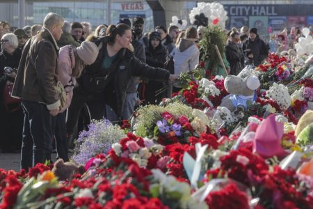 Numerous People Lay Flowers in front of Crocus City Hall