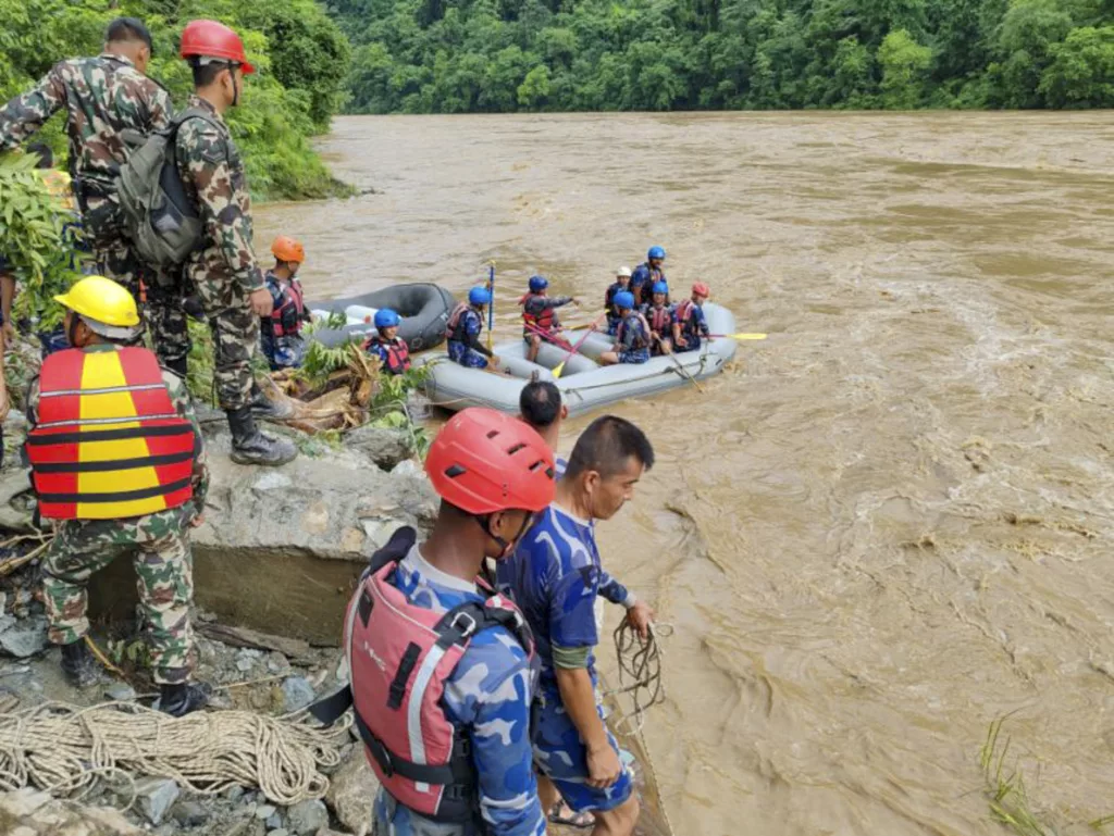 At least 60 people missing after two passenger buses are swept away by a landslide