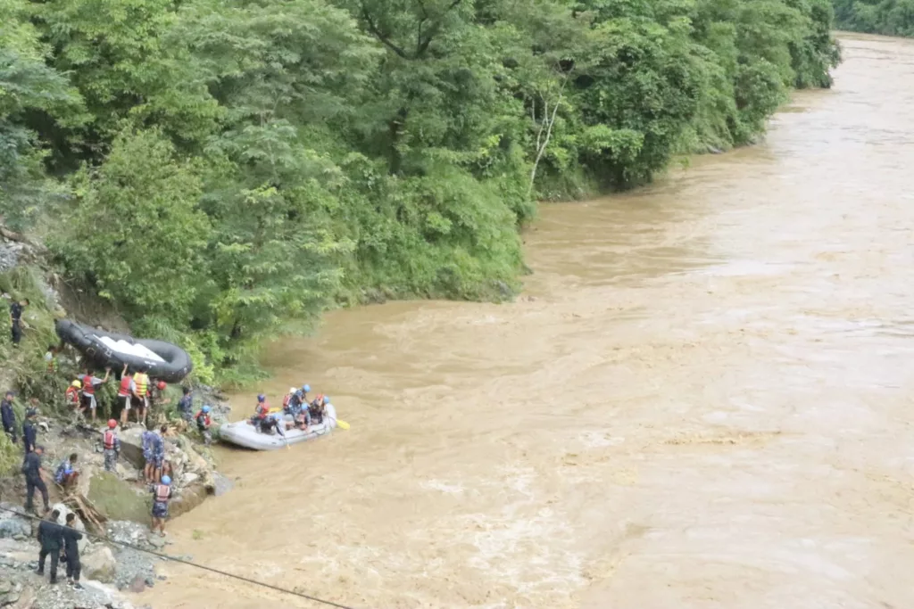 At least 60 people missing after two passenger buses are swept away by a landslide
