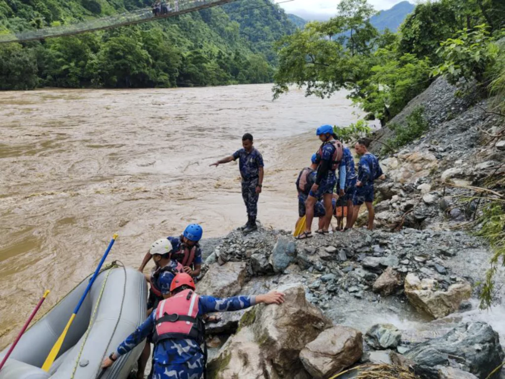 At least 60 people missing after two passenger buses are swept away by a landslide