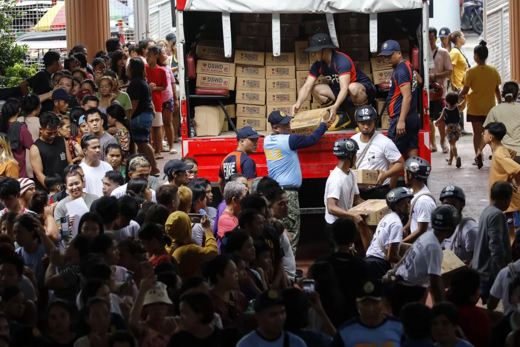 Residents affected by Typhoon Gaemi receive supplies at Marikina City's evacuation center