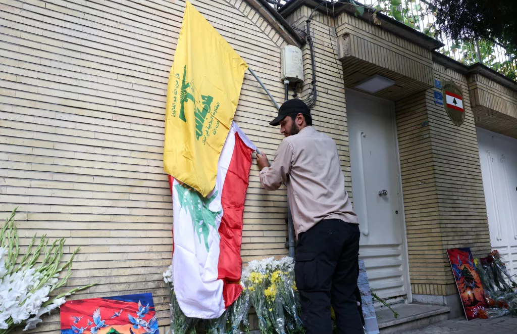 Iranians lay flowers in front of the Lebanese embassy in Tehran