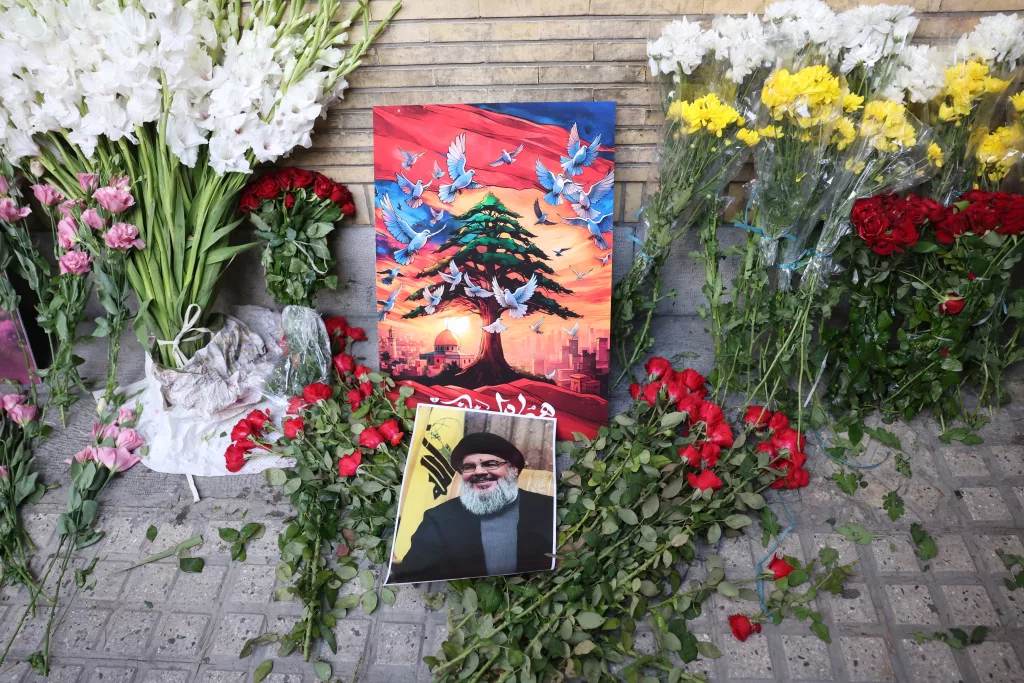 Iranians lay flowers in front of the Lebanese embassy in Tehran