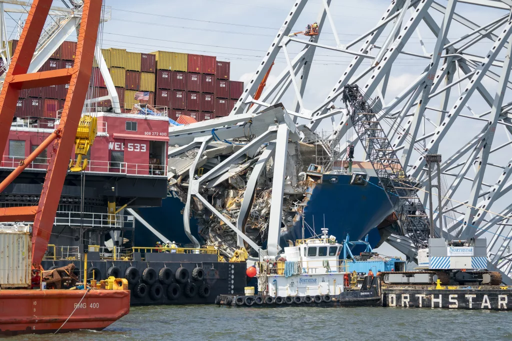 Crews work to clear the wreckage of the Francis Scott Key Bridge in Baltimore