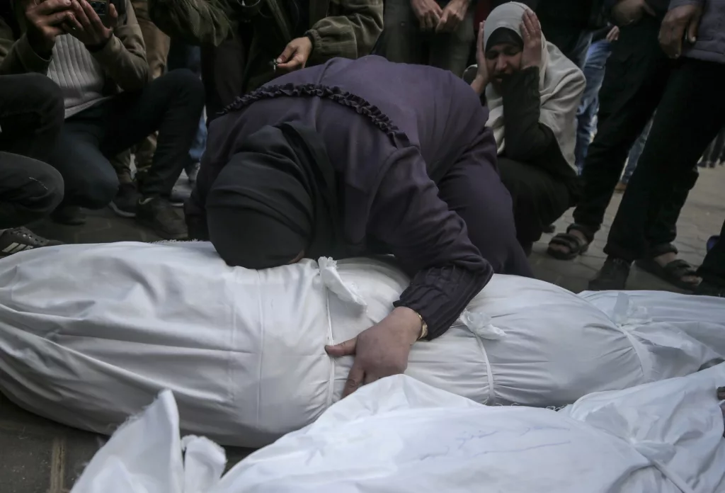 Palestinians mourn their dead at Deir Al Balah hospital after Israeli airstrike in central Gaza